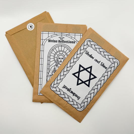 Three brown paper packages with black and white religious designs on a white background
