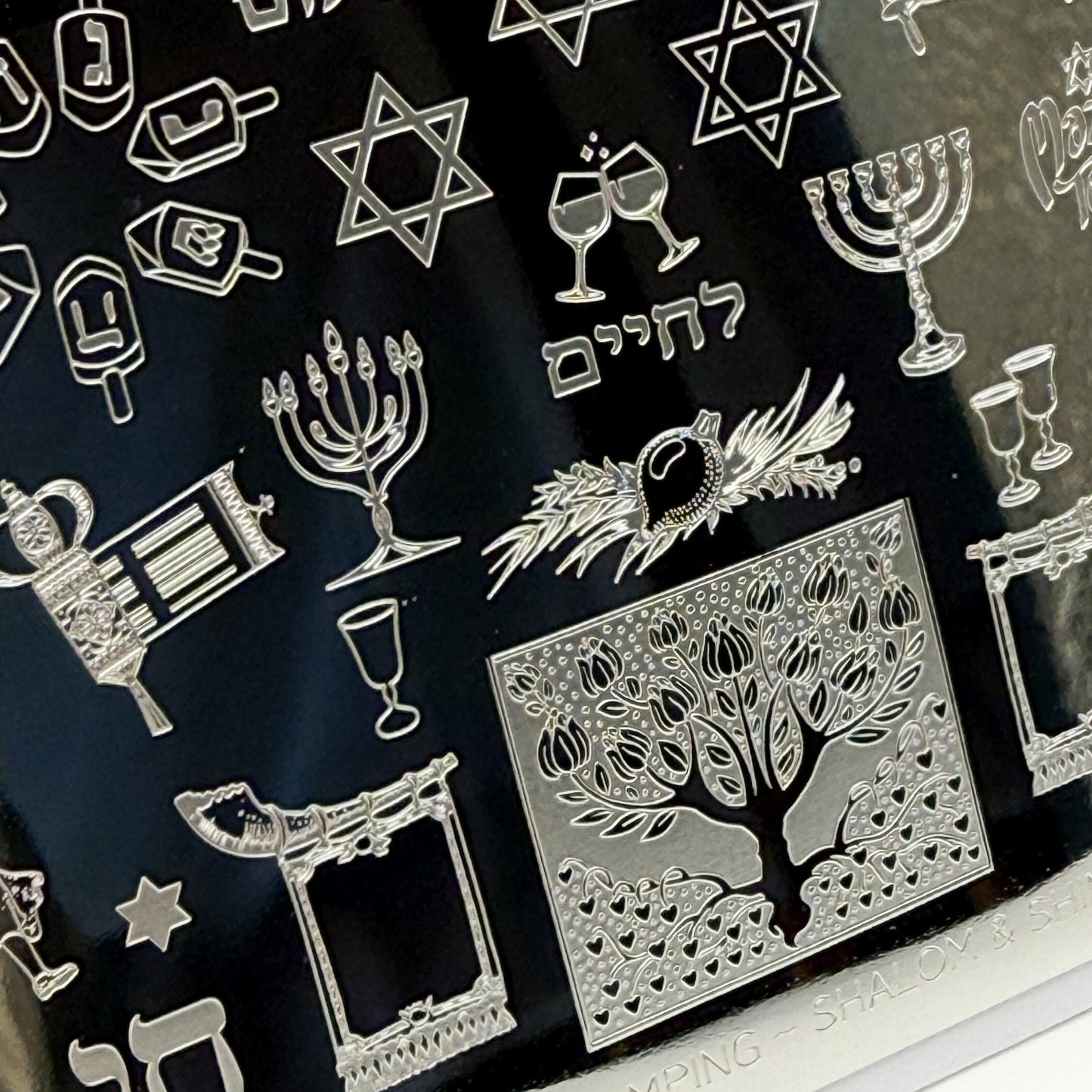 Collection of silver Jewish symbols on a black background
