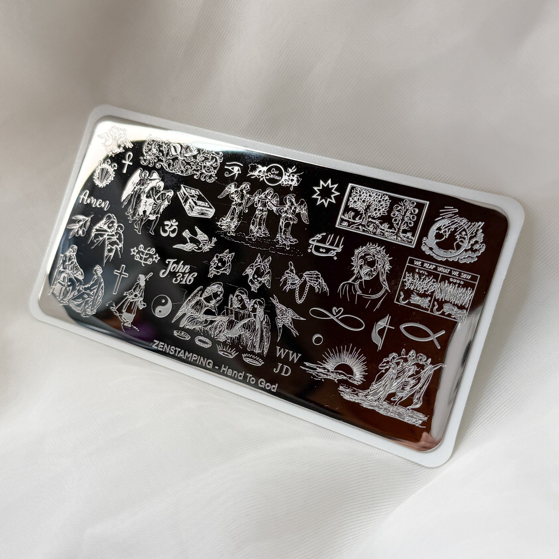 Nail art stamping plate with various Christian designs on a white background