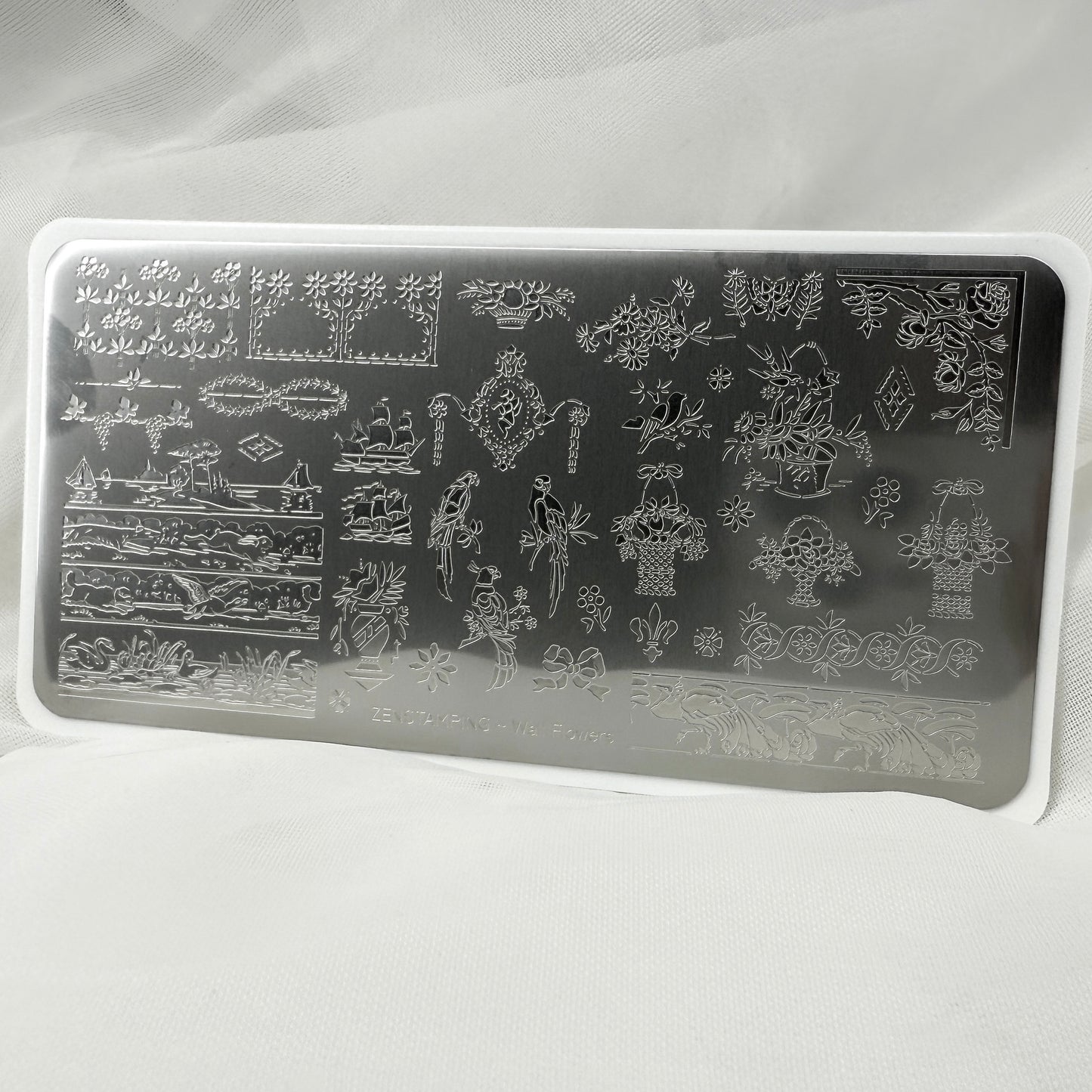 Rectangular nail art stamping plate with intricate designs on a white background