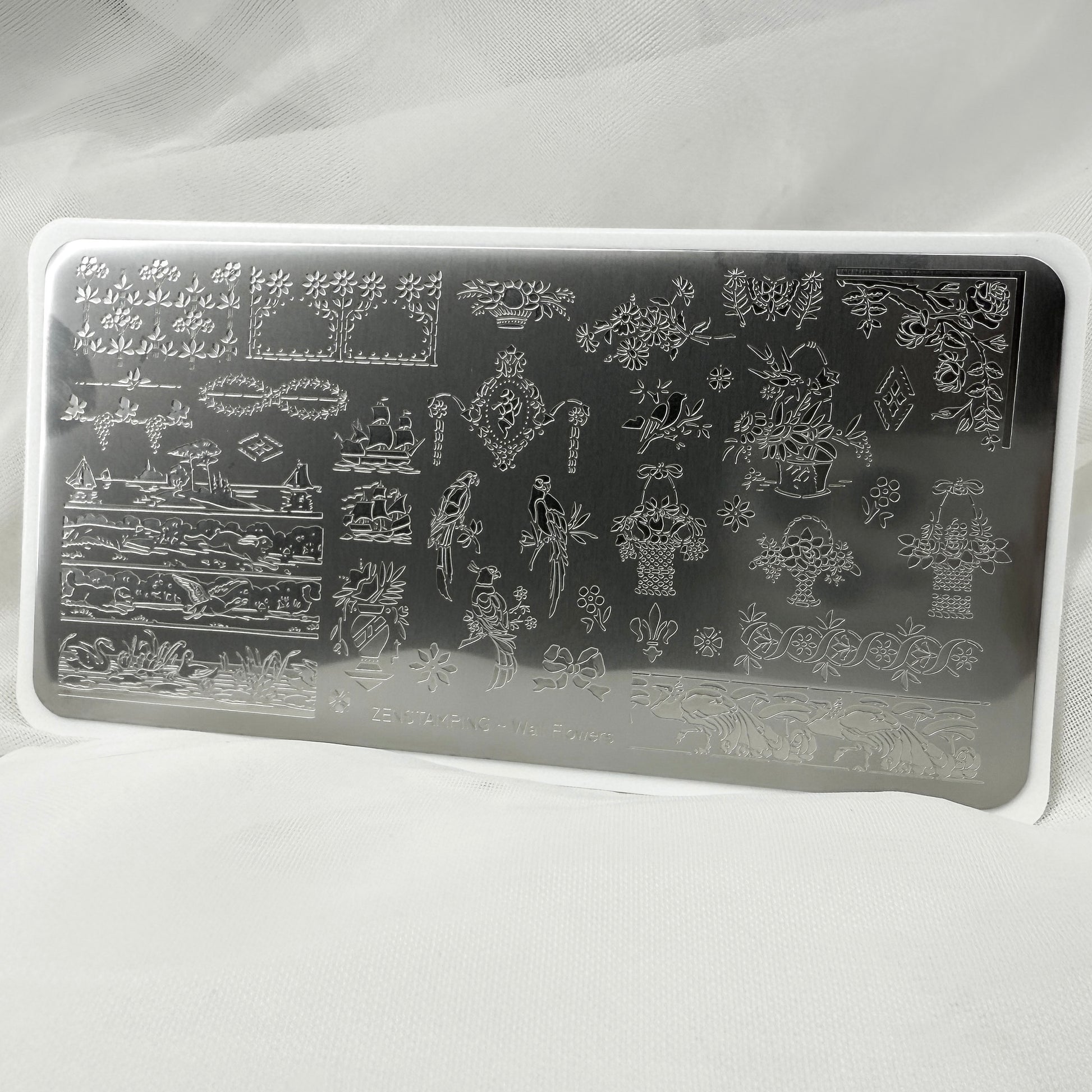 Rectangular nail art stamping plate with intricate designs on a white background