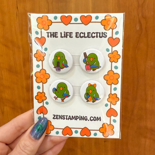 Set of four green cartoon character buttons on a 'The Life Eclectus' card with decorative elements.