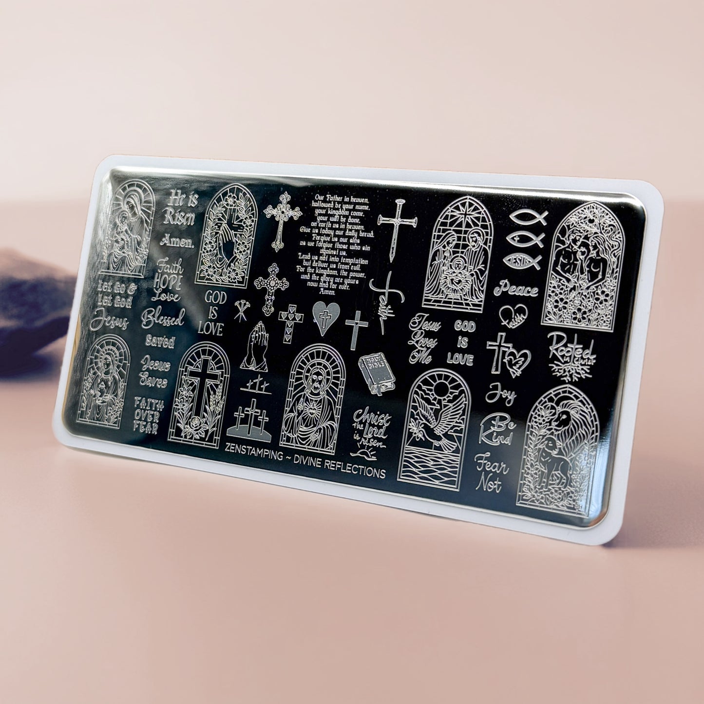 Decorative stamping plate with religious designs and text on a beige background