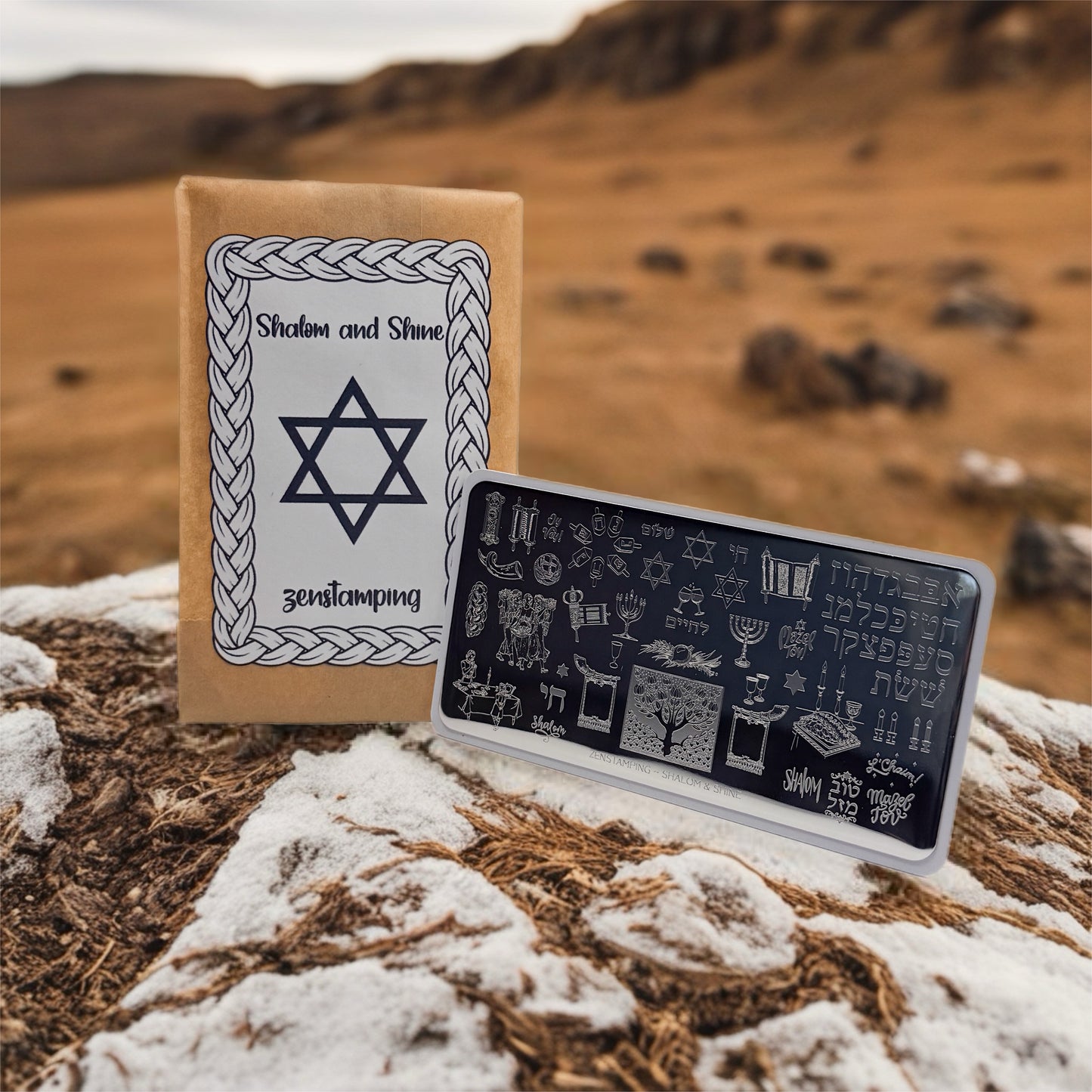 Nail stamping plate with brown paper envelope with Star of David design in a mountainous landscape
